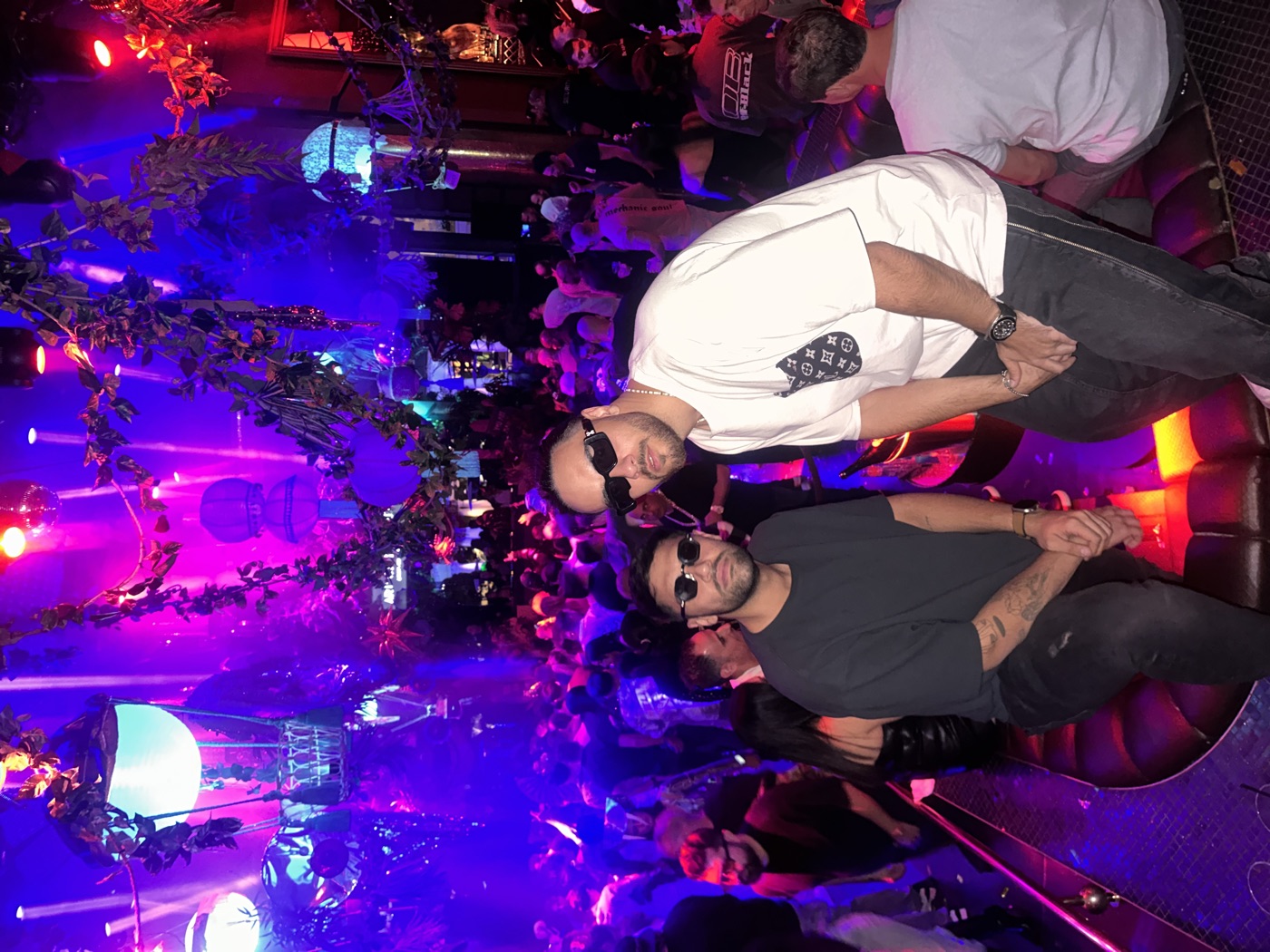 DOSO and Mehrad in a packed nightclub under purple lights