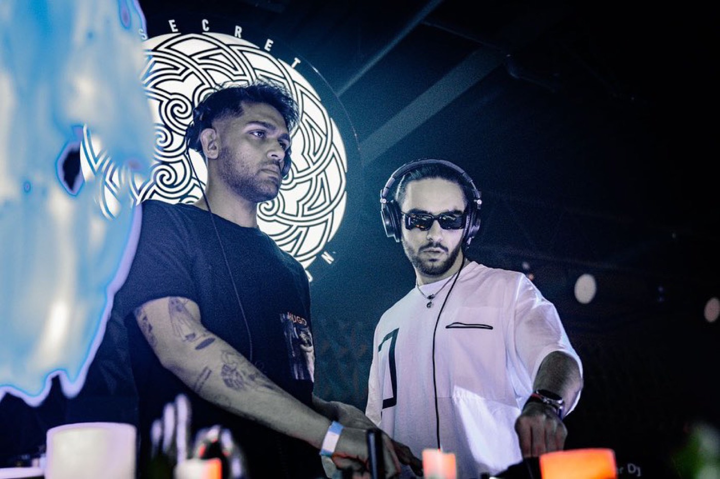 DOSO and Mehrad in headphones behind the decks